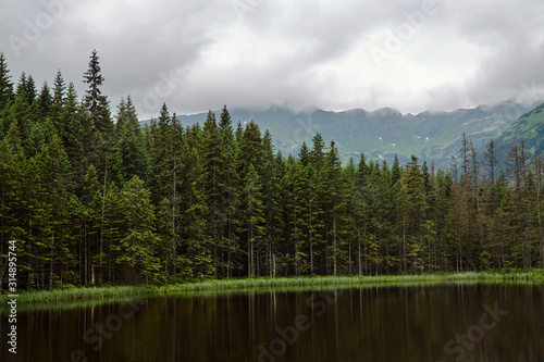 Post-glacial lake Smreczynski Pond in spring in the mountains of the Tatra Mountains in Poland.