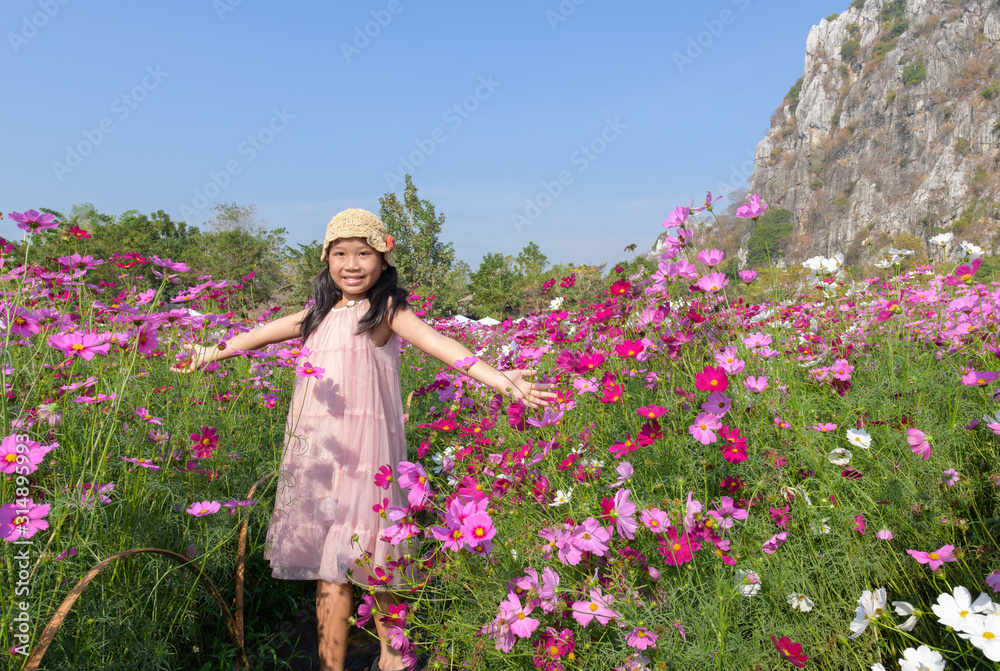 Happy cute asian girl smile in cosmos garden Happy cute asian girl smile in cosmos garden