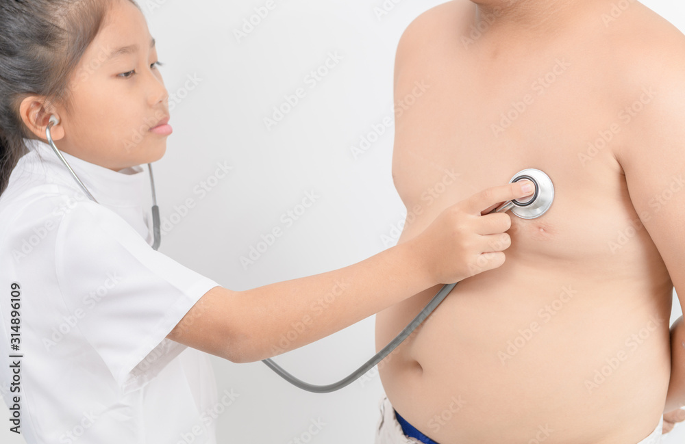Little doctor check heart by stethoscope to obese boy Little doctor check heart by stethoscope to obese boy