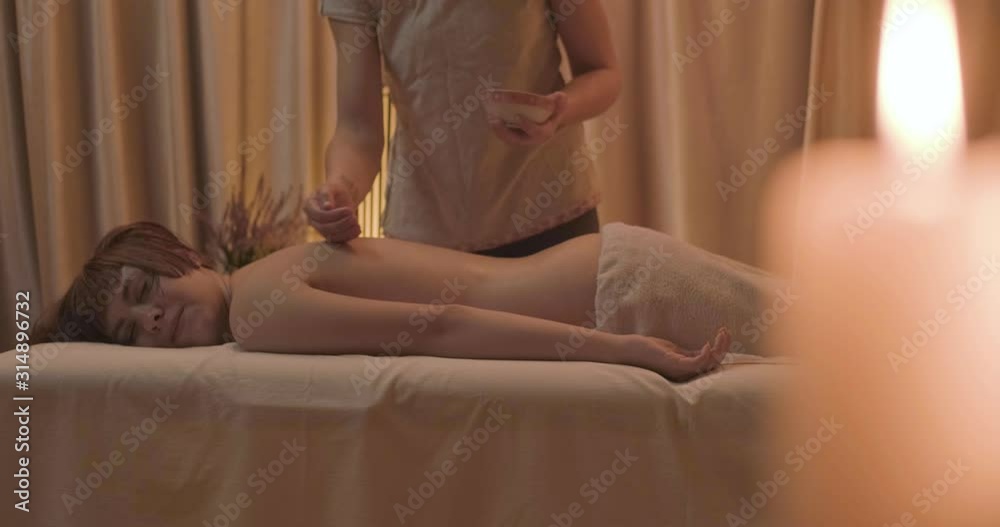 Young woman relaxing during body massage , 4k UHD Young woman relaxing during body massage , 4k UHD