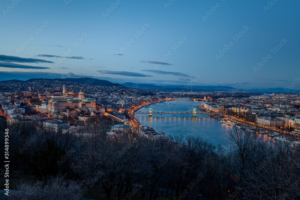 Aerial view Budapest, Hungary by evening, night. Buda castle, Chain bridge and Parliament building