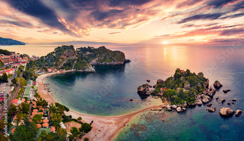 View from flying drone. Attractive morning view of Bella island. Exotic spring seascape of Mediterranean sea. Fantastic sunrise in Mazzaro' town, Sicily, Itale, Europe. photo