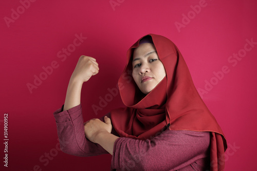 Muslim Lady Shows Strong Muscle Gesture © airdone