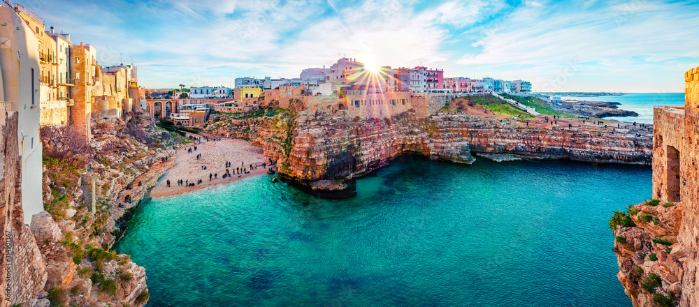 Panoramic spring cityscape of Polignano a Mare town, Puglia region, Italy, Europe. Marvelous evening view of Adriatic sea. Traveling concept background.