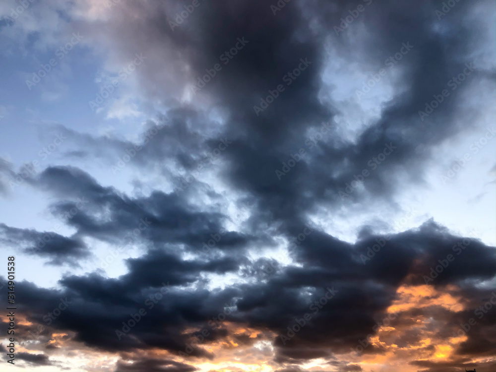 Fototapeta premium Dark clouds in the sky with a dramatic mood at sunset