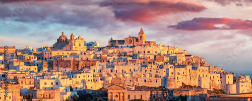 Panoramic morning cityscape of Ostuni town. Fantastic sunrise in Apulia, Italy, Europe. Traveling concept background. photo