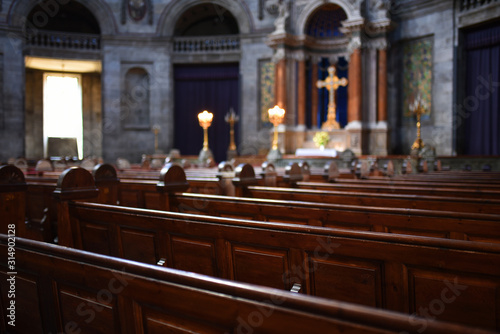Interior of Catholic church with selective focus on benches