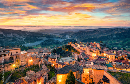 Fantastic red sky above Stilo town. Unbelievable spring scene of Apulia, Italy, Europe. Traveling concept background.