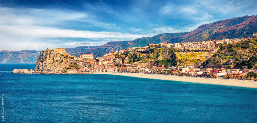 Panoramic morning view of Scilla town with Ruffo castle on background, administratively part of the Metropolitan City of Reggio Calabria, Italy, Europe. Stunning spring seascape of Mediterranean sea.