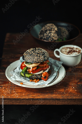 Burger Cup coffee tea Breakfast lunch dinner black background © Natalya