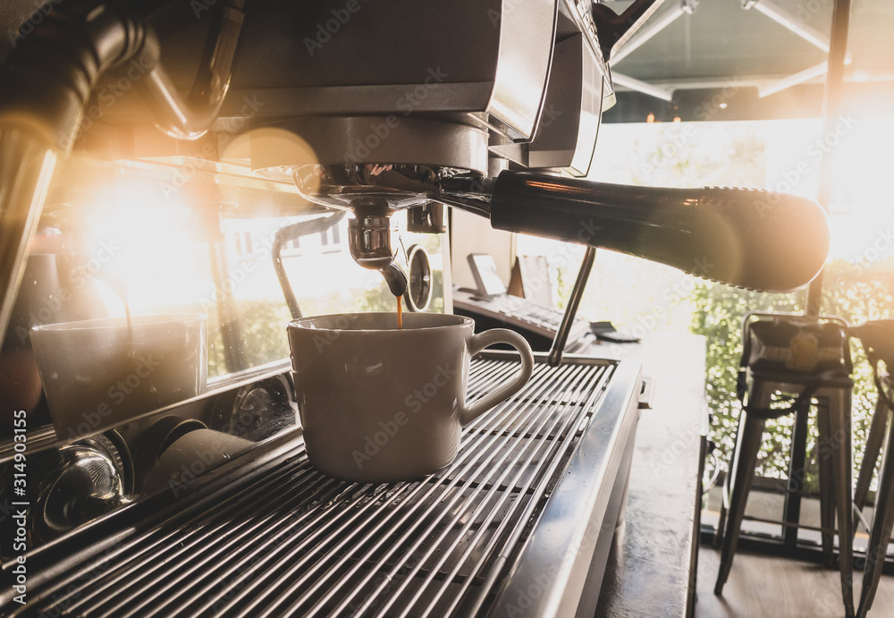 Close-up of espresso pouring from coffee machine by Professional coffee brewing. Close-up of espresso pouring from coffee machine by Professional coffee brewing.