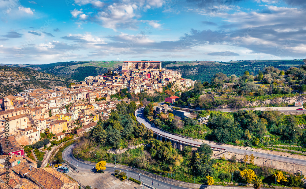 Colorful spring cityscape of Ragusa town with Palazzo Cosentini and Duomo di San Giorgio church on background. Gorgeous afternoon scene of Sicily, Italy, Europe. Traveling concept background.
