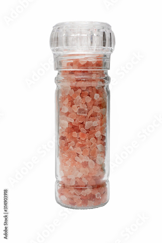 Fototapet Close up of  Pink Himalayan crystal salt in glass grinder bottle isolated on whi