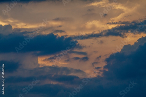 Dawn sky with dark clouds illuminated by the sun.