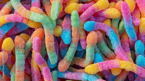 фотографія Pile of neon sugary gummy worms or  chewy sour crawlers background
