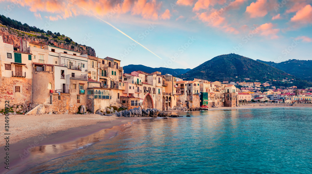 Attractive evening cityscape of Cefalu town. Amazing sunset on Mediterranean sea, Sicily, Italy, Europe. Traveling concept background.