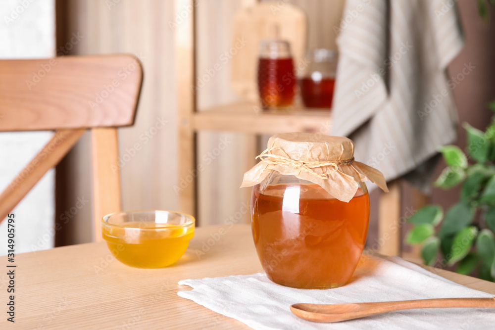 Tasty fresh organic honey on wooden table Tasty fresh organic honey on wooden table