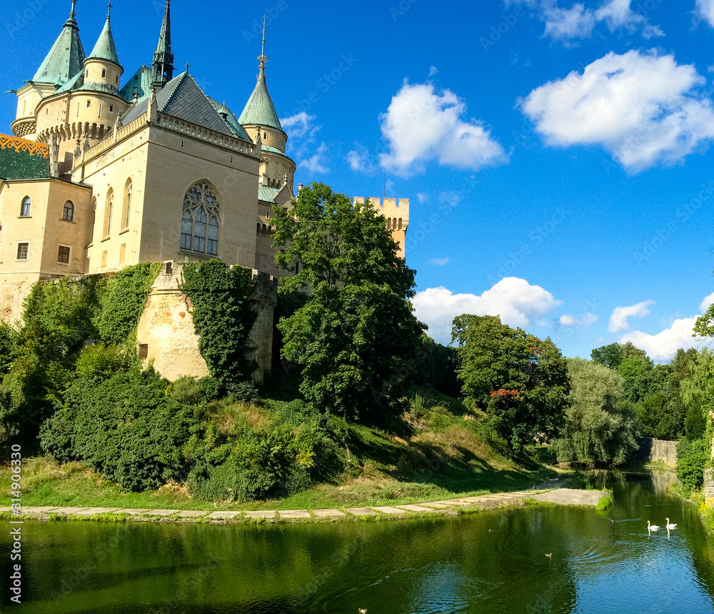 Bojnice Castle, a romantic castle in the middle of Slovakia, towers and a beautiful park with trees around Europe travel