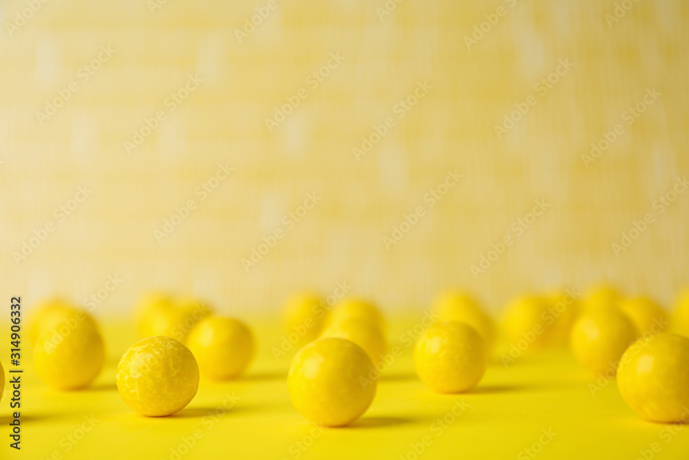 Delicious lemon chewing gums on yellow table Delicious lemon chewing gums on yellow table