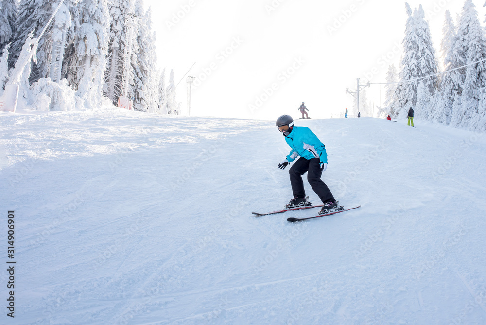 Skier in motion, skiing in mountain ski resort 