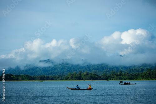 The view of Kaptai lake, a boat woman is working for her lives photo