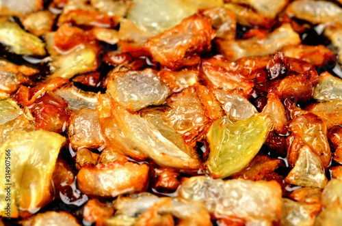 Golden chopped onion fried in oil. Close-up