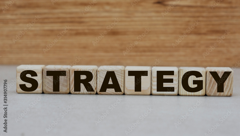 concept word strategy on cubes on a wooden background concept word strategy on cubes on a wooden background