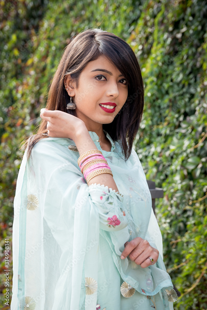 Bracelets on the girl's hands. Traditional accessories of Indian girls. Girl in traditional Indian clothing, salwar kameez. An Indian girl stands on the street of the city. Bracelets on the girl's hands. Traditional accessories of Indian girls. Girl in traditional Indian clothing, salwar kameez. An Indian girl stands on the street of the city.