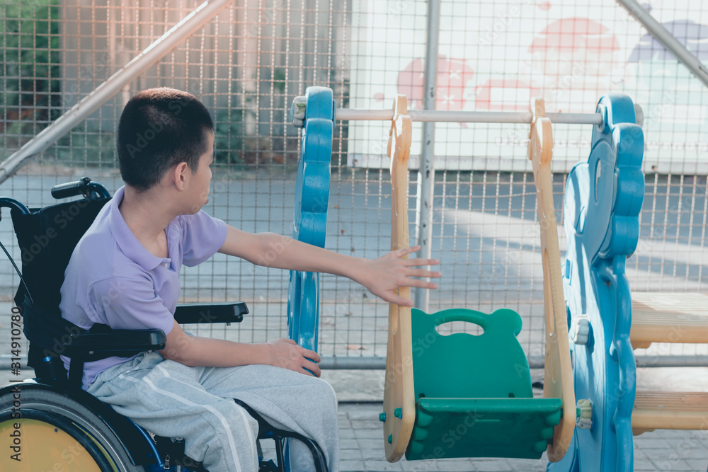 Disabled child on wheelchair is playing,learning and exercise in the outdoor playground like other people,Lifestyle of special child,Life in the education age of children,Happy disability kid concept.