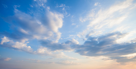 Blue sky clouds background. Beautiful landscape with clouds and orange sun on sky