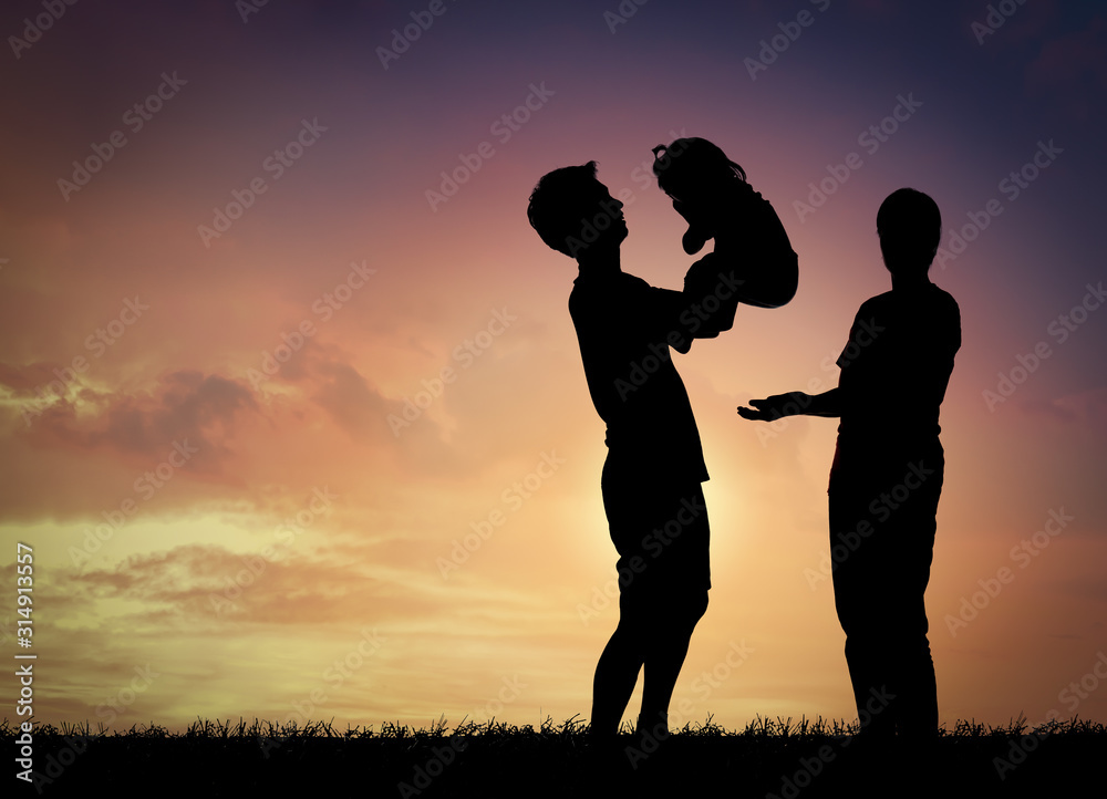 Silhouette family,father, mother and children against the sunset.