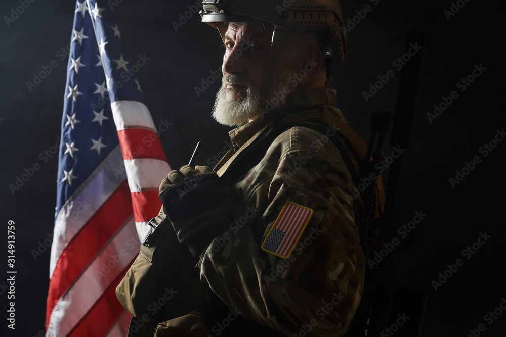 American military veteran with gun on shoulder. American military veteran with gun on shoulder.