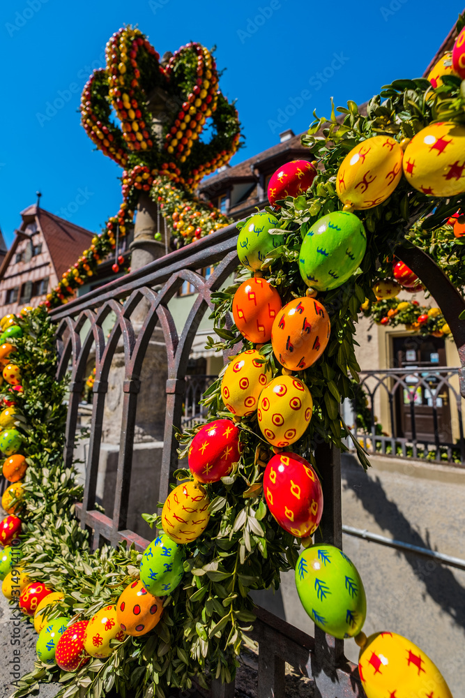 Traditionally decorated easter fountain seen in Bavaria (Germany). Easter fountain. Osterbrunnen. Traditional german easter eggs outdoor decoration. Rothenburg ob der Tauber, Bavaria