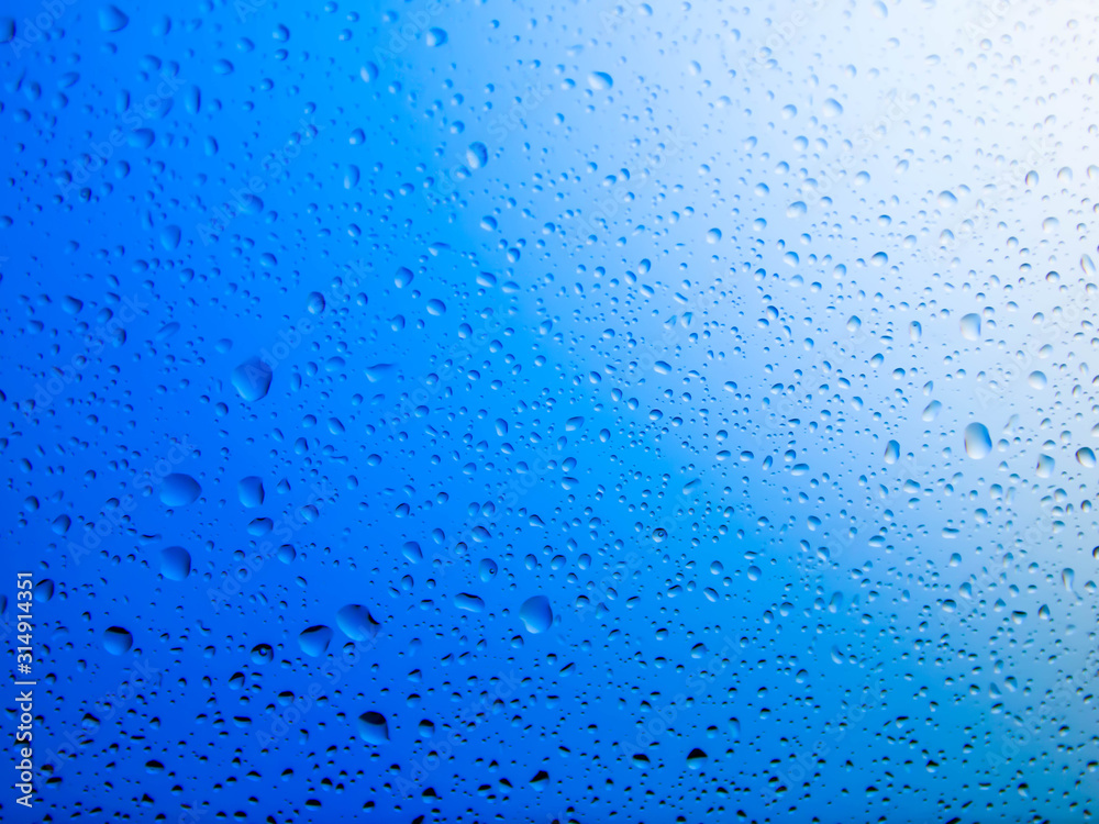 Obraz premium water drops on glass background.Blue water drops on mirror background.