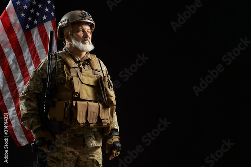 Old military officer holding sniper rifle.