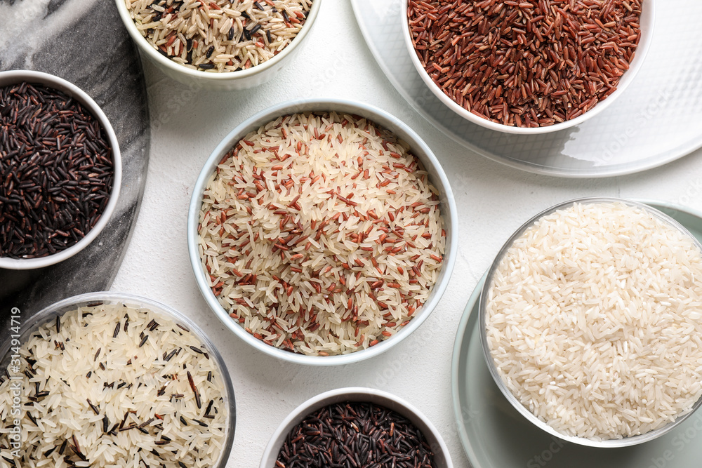 Different sorts of rice on white table, flat lay Different sorts of rice on white table, flat lay