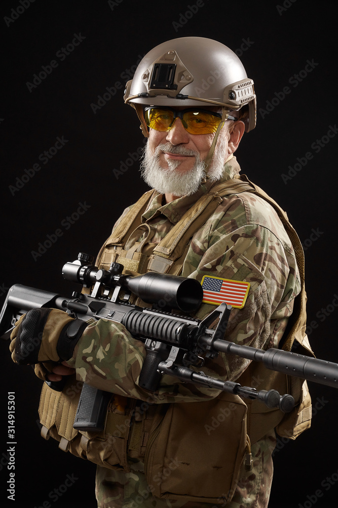 Military veteran with sniper rifle isolated on black. Military veteran with sniper rifle isolated on black.