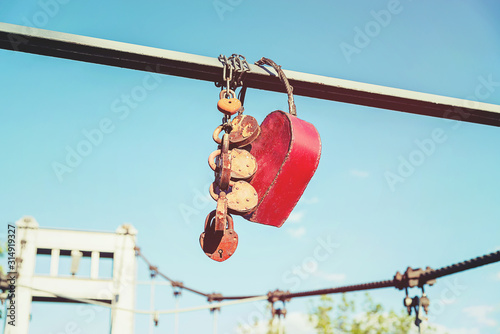huge padlock in conjunction with small padlocks on the bridge