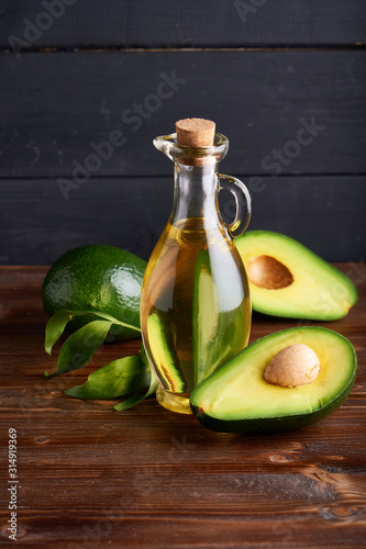 Healthy Avocado oil in glass bottles. Dark background Copy space