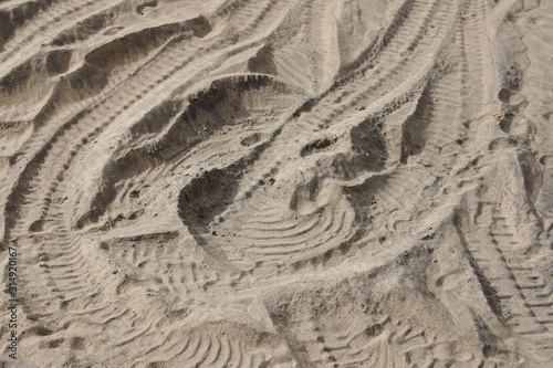 Full frame close-up view of vehicle tracks in the beach sand