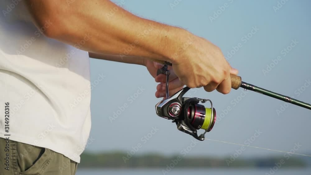 Man is holding his fishing rod Man is holding his fishing rod