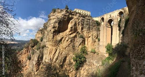 Bridge in Ronda famous and romantic Andalusia Spain. Photo from the viewing point under the bridge. You can see the rocky cliffs of both sides of the bridge