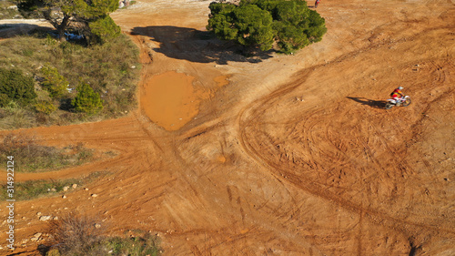 Aerial drone of moto cross dirt bike in compete in dirt track photo