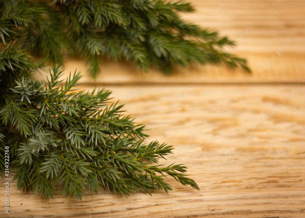 close-up image of fir branches on wooden background close-up image of fir branches on wooden background