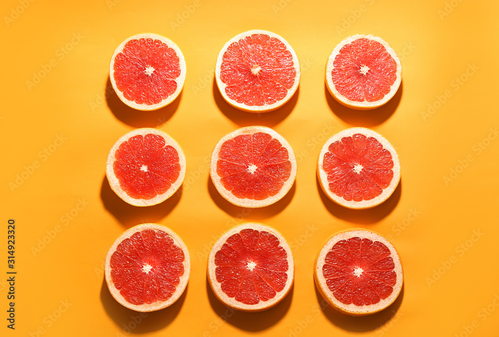 Flat lay composition with tasty ripe grapefruit slices on orange background Flat lay composition with tasty ripe grapefruit slices on orange background