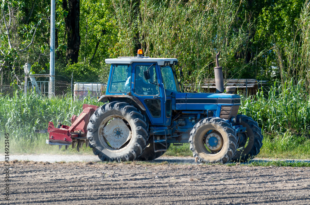 old agricolture tractor during work old agricolture tractor during work
