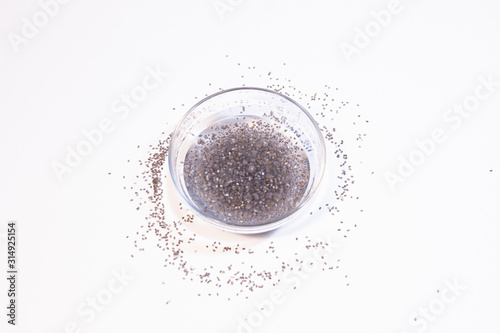 Jelly with chia seeds and water in glass bowl on white background