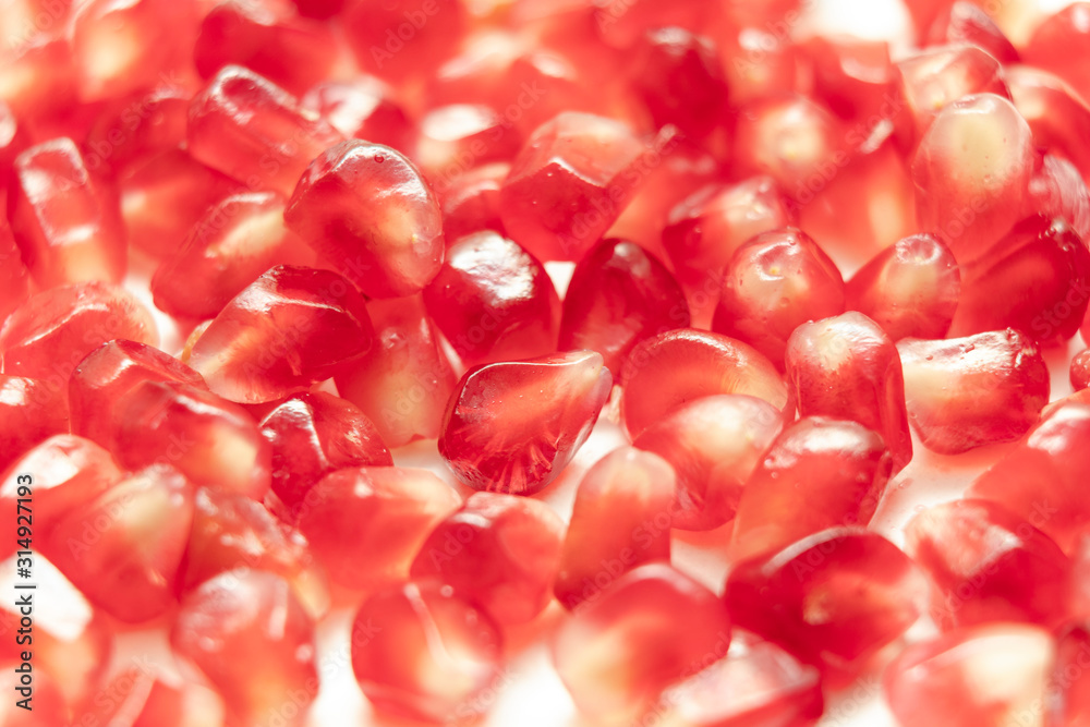 Red pomegranate seeds, white background. Mono Shooting. Juicy bright red fruit. Love.