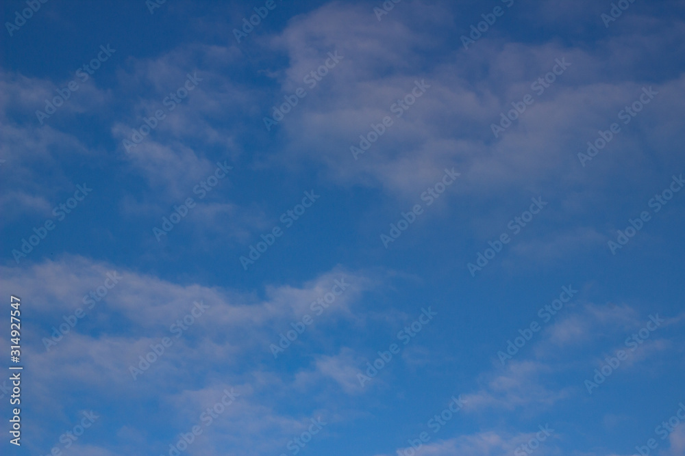 Blue sky background with white and gray clouds. Beautiful image of a huge sky and clouds. soft focus