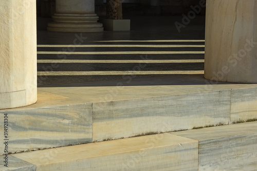 elements of marble columns and steps along with shadows on a sunny day